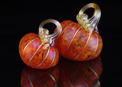 Two glass pumpkins, one bigger than the other