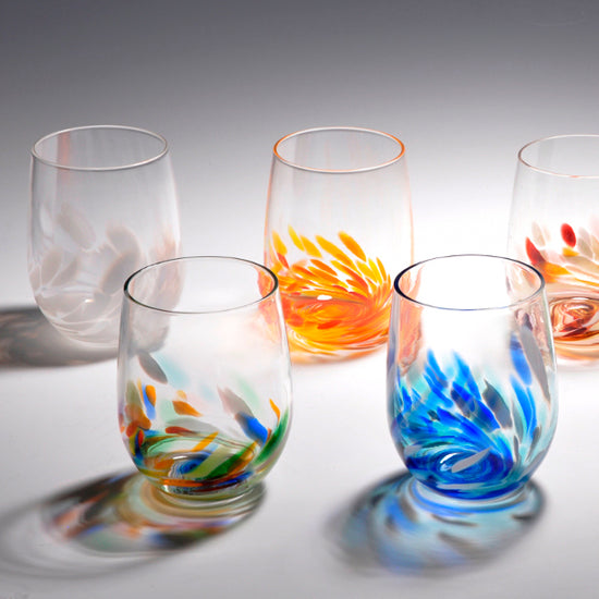 Stemless wine tumblers with colorful abstract decorative accents.